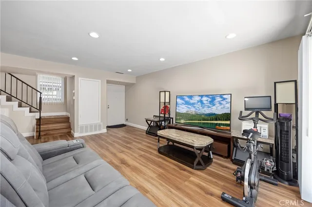 a living room with furniture flat screen tv and pool table