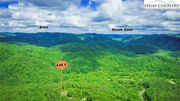 a sign of golf club on a wall under a tree