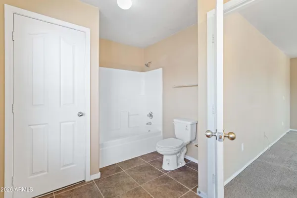 a bathroom with a toilet sink and a mirror