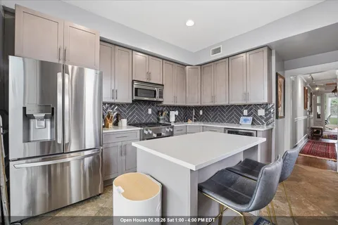 a kitchen with a stove a sink and a refrigerator