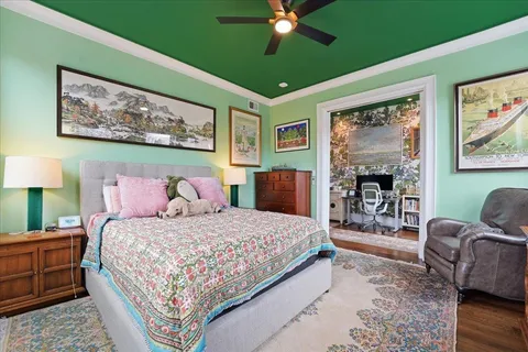a bedroom with a bed wooden floor and window