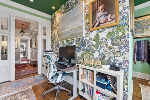 a work room with furniture and a flat screen tv