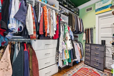 a view of walk in closet with clothes