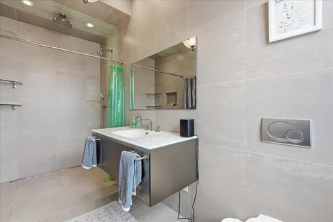 a bathroom with a sink a toilet and mirror