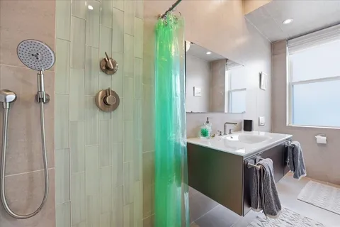 a bathroom with a sink a light fixture and a mirror