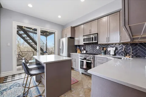 a kitchen with a stove a sink and a refrigerator