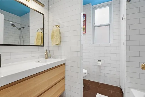 a bathroom with a sink a toilet and mirror