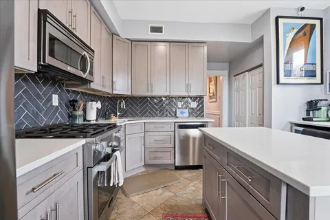 a kitchen with a stove microwave and sink