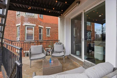 a building outdoor space with patio furniture and potted plants