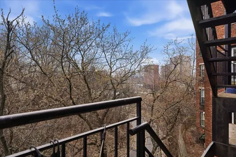 a view of trees from a balcony