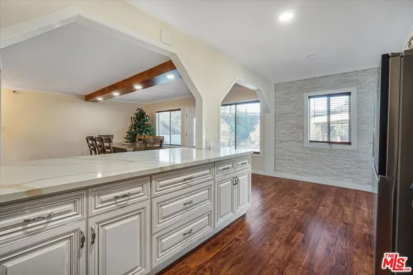 a kitchen with stainless steel appliances a stove microwave and sink