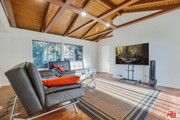 a living room with lots of furniture and a wooden floor