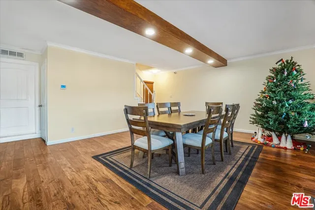a dining room with furniture window and wooden floor