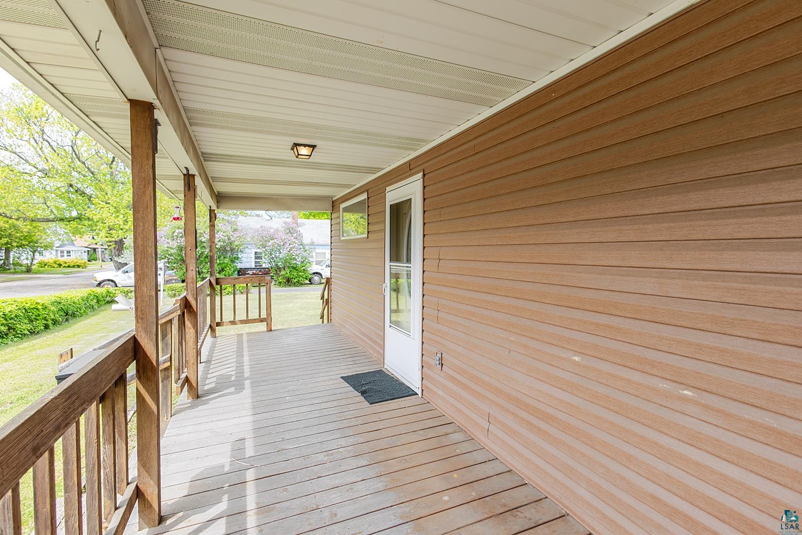 438 9th Street Cloquet, MN 55720 - Photo 7 of 27 Covered front porch with wood-finish decking and railing
