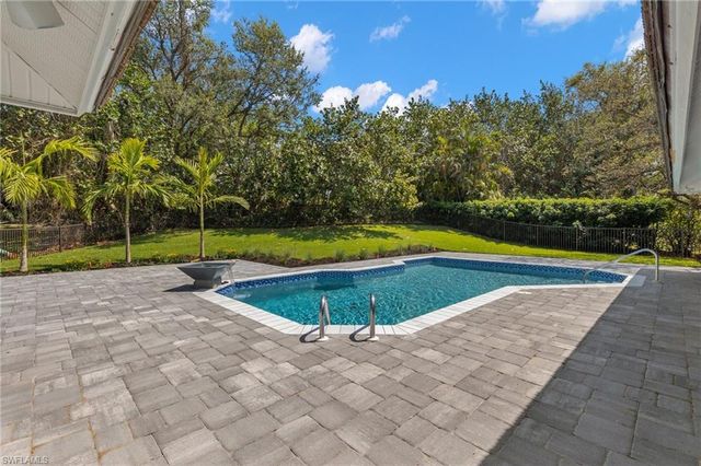 a view of a swimming pool with an outdoor space and seating area