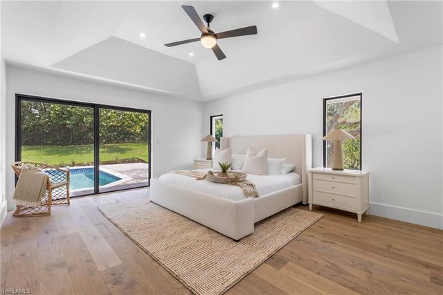 a living room with furniture and large windows