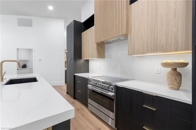 a kitchen with a stove and a refrigerator