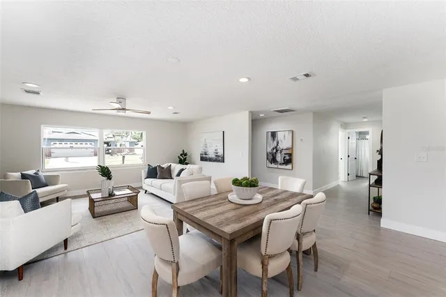 a view of a dining room with furniture window and wooden floor