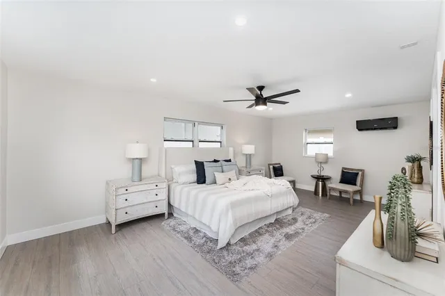 a spacious bedroom with a bed a couch and a window