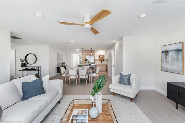 a living room with furniture and a dining table