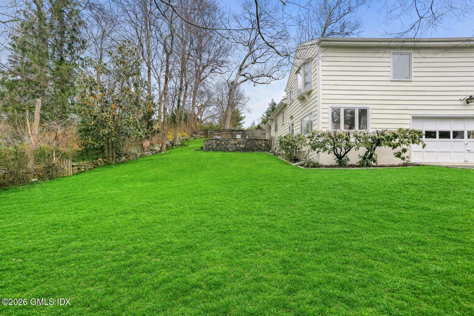 30 Weston Hill Road Riverside, CT 06878 - Photo 27 of 31 Suburban backyard with lush green lawn