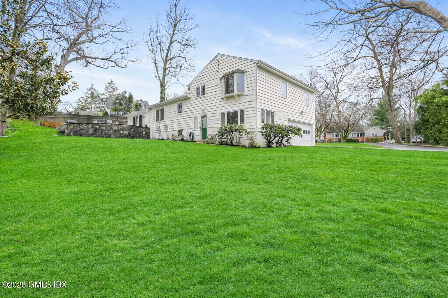 30 Weston Hill Road Riverside, CT 06878 - Photo 28 of 31 Bright suburban home on green lawn