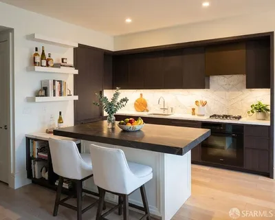 a kitchen with stainless steel appliances kitchen island granite countertop a sink and cabinets