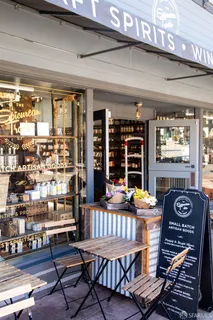 a table and chairs in a room next to a window