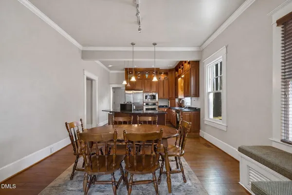 a view of a dining room with furniture window and wooden floor