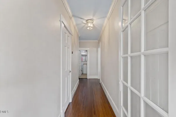 a view of a hallway with wooden floor and staircase