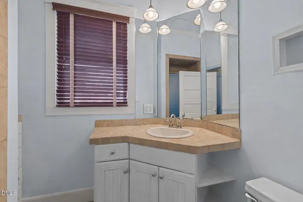 a bathroom with a sink a vanity and a mirror