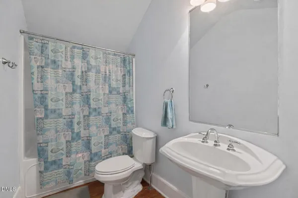 a bathroom with a sink toilet and a mirror