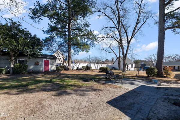 a view of a yard with a house in the background