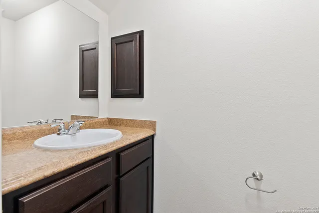 a bathroom with a sink and a mirror