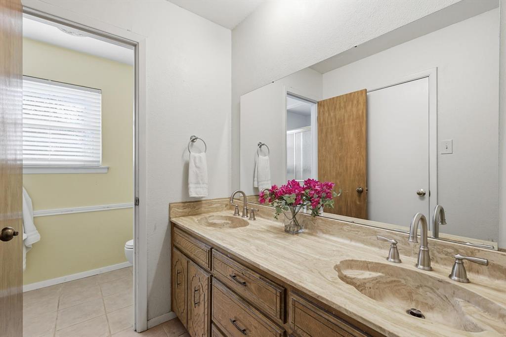 11436 Ridgeview Circle Fort Worth, TX 76244 - Photo 14 of 33 a bathroom with a granite countertop sink and a mirror
