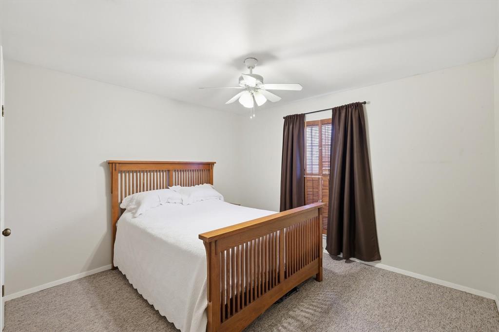 11436 Ridgeview Circle Fort Worth, TX 76244 - Photo 15 of 33 a bedroom with a bed and a chandelier