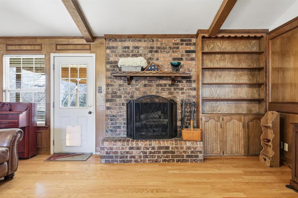 11436 Ridgeview Circle Fort Worth, TX 76244 - Photo 4 of 33 a living room with a fireplace cabinet and a fireplace