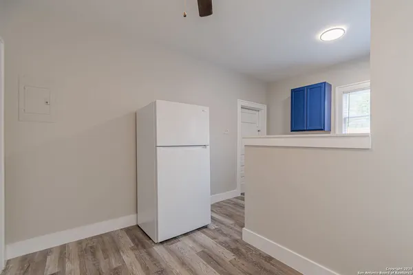 a view of a room with wooden floor