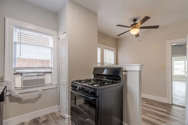 a kitchen with appliances cabinets and a window