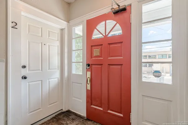 a view of front door with a mirror