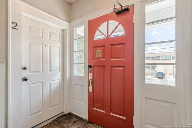 a view of front door with a mirror