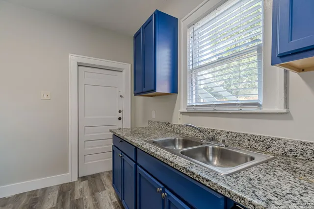 a kitchen with granite countertop a sink and a window