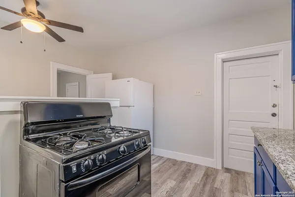 a stove top oven sitting inside of a kitchen