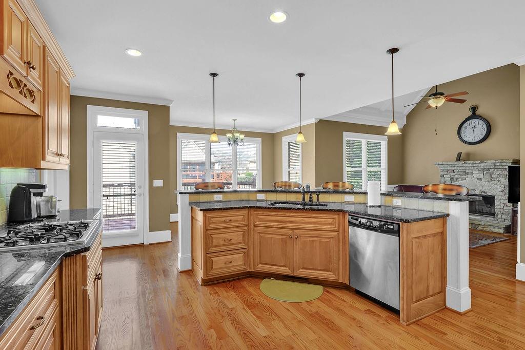 737 Heritage Post Lane Southwest Grayson, GA 30017 - Photo 19 of 50 a kitchen with stainless steel appliances granite countertop a stove a sink dishwasher and a wooden cabinets with wooden floor