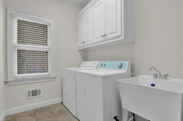a utility room with a sink dryer and washer