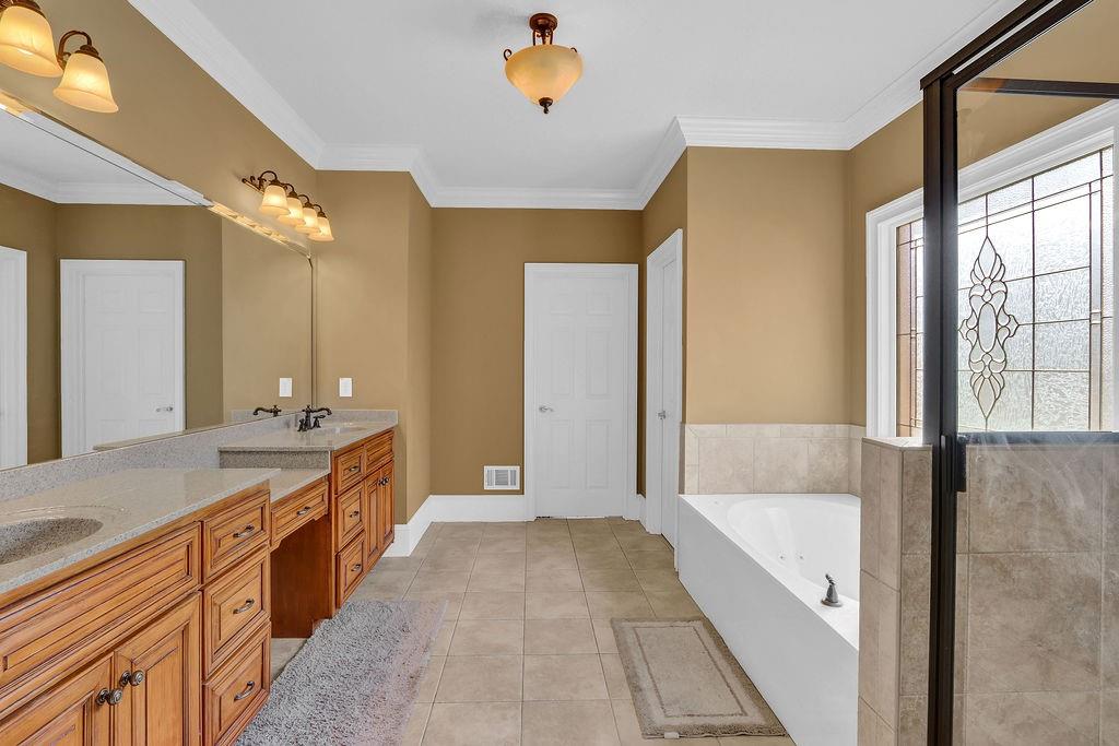 737 Heritage Post Lane Southwest Grayson, GA 30017 - Photo 25 of 50 a spacious bathroom with a tub sink shower and mirror
