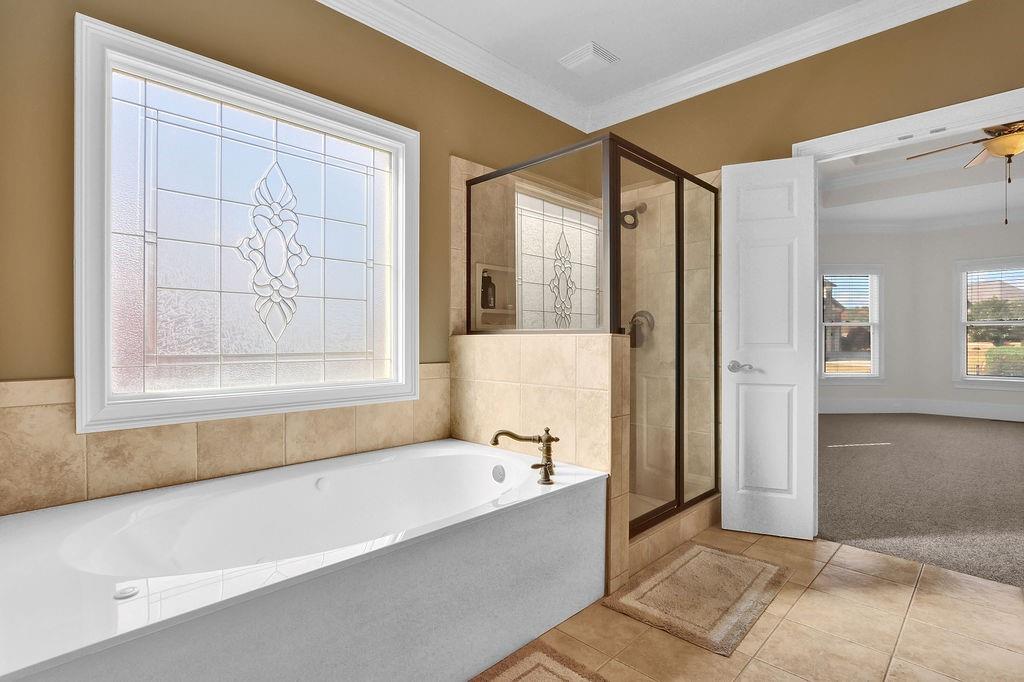 737 Heritage Post Lane Southwest Grayson, GA 30017 - Photo 27 of 50 a bathroom with a bathtub and a shower