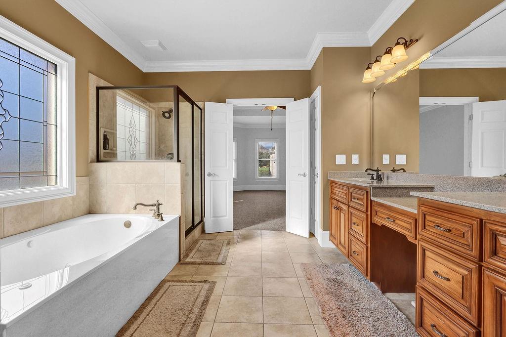 737 Heritage Post Lane Southwest Grayson, GA 30017 - Photo 28 of 50 a spacious bathroom with a tub sink shower and mirror