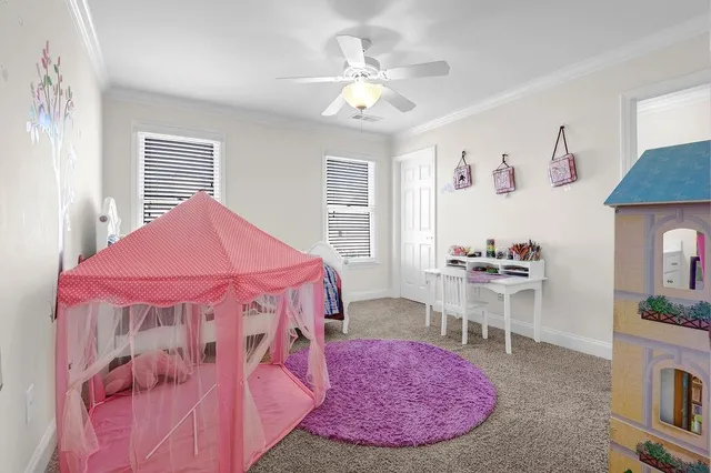 a bedroom with a bed dresser and a window