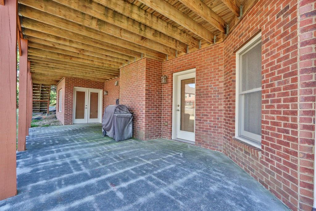 737 Heritage Post Lane Southwest Grayson, GA 30017 - Photo 45 of 50 a view of a porch with a table and chairs